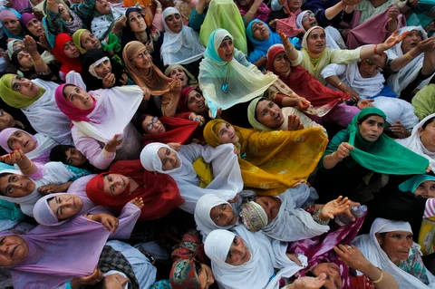 Kashmiri Muslim women raise their arms upon seeing a relic
of Prophet Mohammed during Meeraj-un-Nabi celebrations at Hazratbal shrine in
Srinagar. (Photo: Reuters)