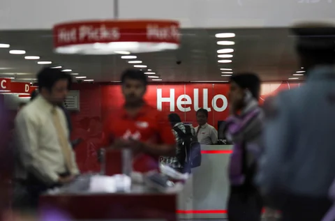 Customers stand inside a Vodafone Group Plc retail store in Mumbai, India (Photographer: Dhiraj Singh/Bloomberg)