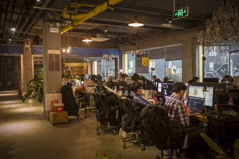 Residents work at their computers at a coworking community in China (Photographer: Qilai Shen/Bloomberg)