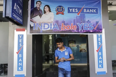 A customer exits a Yes Bank Ltd. automated teller machine (ATM) in Ahmedabad. (Photographer: Dhiraj Singh/Bloomberg)