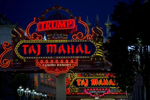Signage stands outside the Trump Taj Mahal casino and hotel, owned by Trump Entertainment Resorts Inc. (Photographer: Andrew Harrer/Bloomberg) 