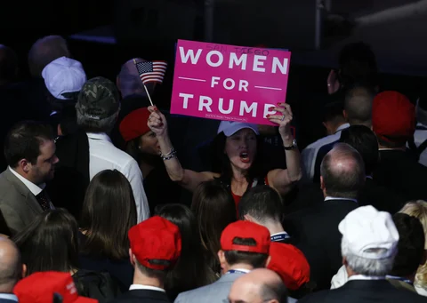 An attendee holds a “Women For Trump” sign during an election night party for U.S. President-elect Donald Trump at the Hilton Midtown hotel in New York, U.S. (Photographer: Andrew Harrer/Bloomberg) 