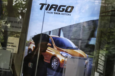 An advertisement for the Tata Motors Tiago hatchback is displayed inside the Prabhadevi Concorde Motors India Ltd. dealership in Mumbai (Photographer: Dhiraj Singh/Bloomberg)