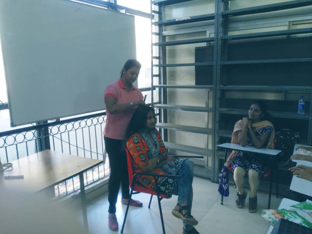 A hair styling session in progress at the National Yuva Cooperative Society in Mumbai, India. (Photographer: Hormaz Fatakia/BloombergQuint)
