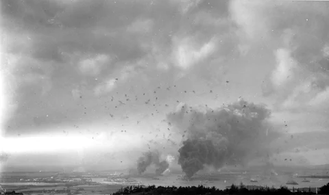A panorama view of Pearl Harbor, during the Japanese raid on December 7, 1941, with anti-aircraft shell bursts overhead. (Image: Wikimedia Commons)