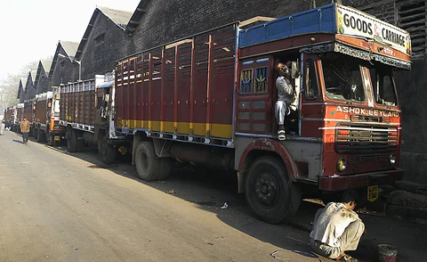 An Indian truckdriver uses the side-view mirror of his Ashok Leyland Ltd. truck to shave prior to heading out on the day’s runs in Mumbai. (Photographer: Santosh Verma/Bloomberg News)
