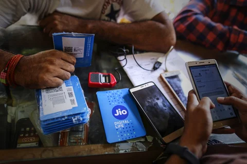 A customer holds a SIM card packet in Mumbai, India. (Photographer: Dhiraj Singh/Bloomberg) 