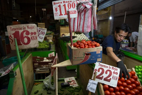 A vendor arranges tomatoes for sale at the Central de Abasto market in Mexico City, Mexico, on July 28, 2015. (Photographer: Susana Gonzalez/Bloomberg)