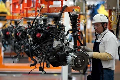 An employee works on the assembly line producing the new Ford Fiesta car, at the Ford Motor plant in Cuautitlan Izcalli, Mexico, on May 11, 2010. (Photographer: Susana Gonzalez/Bloomberg)
