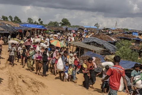 Rohingya people make their way to permanent tents in the Kutupalong Refugee Camp in Cox’s Bazar, Bangladesh, on September 21, 2017. (Photographer: Ismail Ferdous/Bloomberg)