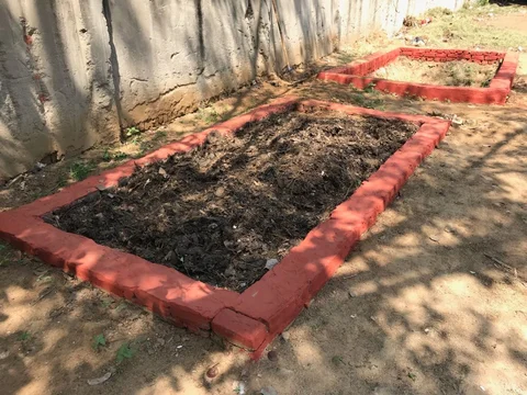 An instance of composting pits. The pits pictured above have been created by residents of a society in Gurugram. (Photographer: Aayush Ailawadi/BloombergQuint)