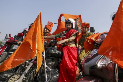 Demonstrators with saffron flags ride motorcycles during a silent protest organized by Marathas. (Photographer: Dhiraj Singh/Bloomberg)