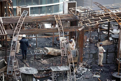 A team of policemen inspect the site after a fire broke out in Mumbai on Friday. (Image: PTI)