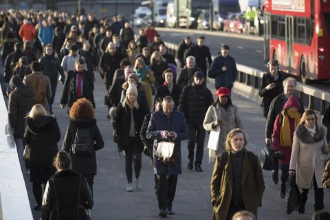 Commuters walk across London Bridge in London, U.K. (Photographer: Jason Alden/Bloomberg)