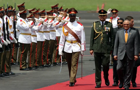 Maumoon Abdul Gayoom, then-President of Maldives, right, receives military honours upon his arrival at Jose Marti Airport in Havana, Cuba on September 14, 2006. (Photographer: Diego Giudice/Bloomberg News)