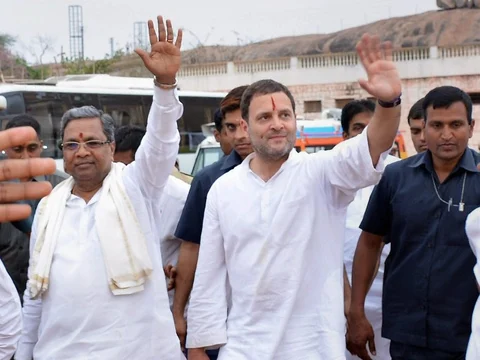Congress President Rahul Gandhi and Karnataka Chief Minister Siddaramaiah wave to people during a rally in Koppal, Karnataka on Feb. 10, 2018. (Photograph: PTI)