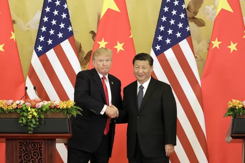 FILE: U.S. President Donald Trump, left, and Xi Jinping, China’s president, shake hands during a news conference in Beijing, China, on Nov. 9, 2017. (Photographer: Qilai Shen/Bloomberg)