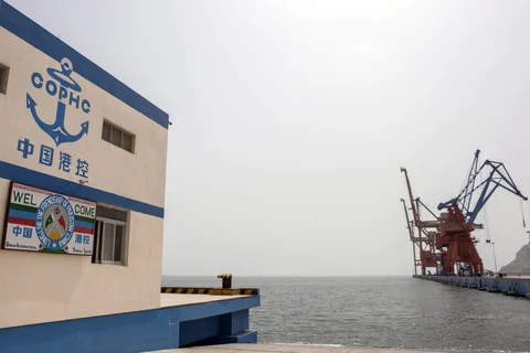 Signage for the China Overseas Ports Holding Co. is displayed on a building wall at Gwadar Port in Gwadar, Balochistan, Pakistan. (Photographer: Asim Hafeez/Bloomberg)