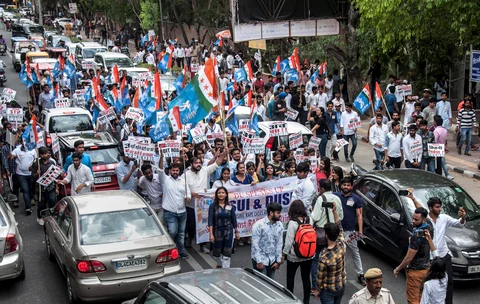 NSUI and DUSU activists display placards and shout slogans during a protest march against rape cases, atrocities against women and various other issues, in North Campus, Delhi University on Friday. (Source: PTI)