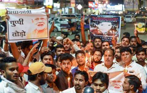 Congress party youth activists hold candles and placards raise slogans against Prime Minister Narendra Modi during candle vigil “Justice March” over governments alleged inaction in Kathua and Unnao gang-rape cases,in Allahabad. (Image: PTI)