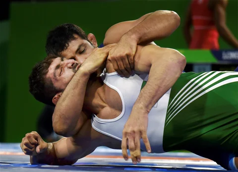 India’s Sushil Kumar wrestles with Pakistan’s Muhammad Asad Butt in the men’s freestyle 74kg wrestling quarterfinal bout. (Source: PTI)