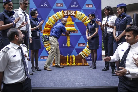 Aditya Ghosh rings a bell during the listing ceremony of the airline at the National Stock Exchange in Mumbai, on Nov. 10, 2015. (Photographer: Dhiraj Singh/Bloomberg)