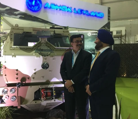 Ashok Leyland’s Managing Director Vinod Dasari (left) stands next to an armoured vehicle at the Defence Expo 2018 in Chennai. (Photographer: Rajender Giri/BloombergQuint)