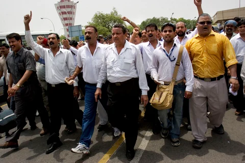 Employees of what was then Indian Airlines march past the domestic terminal at Indira Gandhi International Airport in New Delhi, India, on June 13, 2007. (Photographer: Adam Ferguson/Bloomberg News)