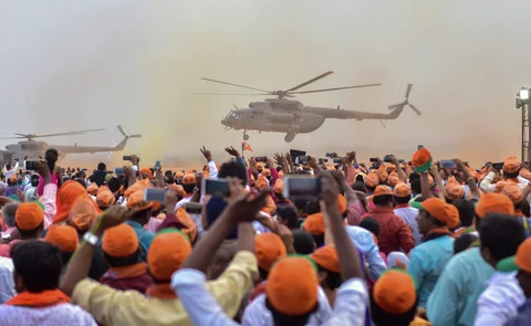 Prime Minister Narendra Modi arrives in a helicopter as BJP supporters cheer during a public rally ahead of Karnataka Assembly elections, in Bengaluru. (Photographer: Shailendra Bhojak/PTI)