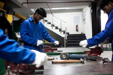 Students file metal during a welding class during vocational training at the Infrastructure Leasing & Financial Services Institute of Skills in New Delhi, India. (Photograph: Udit Kulshrestha/Bloomberg) 