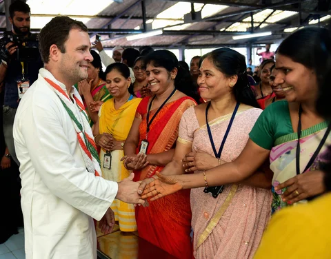 AICC President Rahul Gandhi greets the workers at a garment factory during an interactive session ahead of the Karnataka Assembly election in Bengaluru. (Photographer: Shailendra Bhojak/PTI)