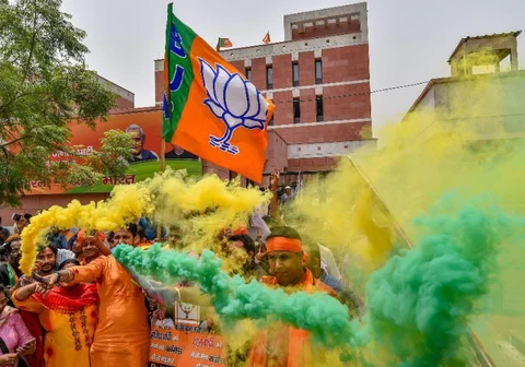 BJP workers celebrate the party’s lead during counting of votes for Karnataka Assembly elections, at the party headquarters in New Delhi. (Photographer: Manvender Vashist/PTI) 