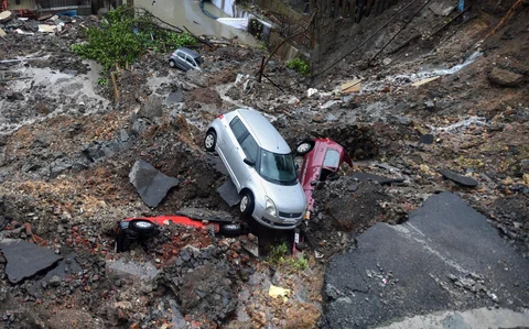 Several cars struck in debris after a wall collapsed at a construction site in Antop Hill, Wadala East area, in Mumbai. (Source: PTI)
