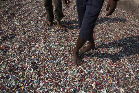 Recovered plastics are laid out to dry on a rooftop in a slum area of India. (Photographer: Brent Lewin/Bloomberg)