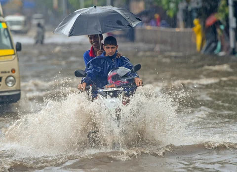 A motorcyclist wades through a water-logged street at Kings Circle after heavy rains in Mumbai on Saturday, June 09, 2018. (Source: PTI)