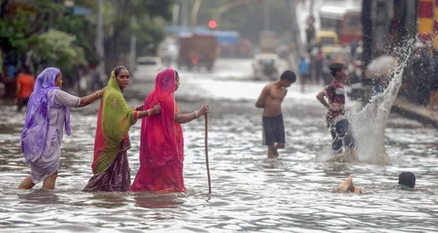 People cross the water-logged street at Kings Circle after heavy rains in Mumbai on Saturday, June 09, 2018. (Source: PTI)