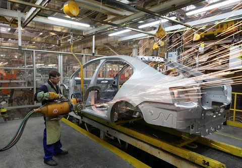 A worker operates a welding machine on an automobile in the Volkswagen AG and Skoda AG welding shop at the Gaz auto plant, operated by Gaz Group, in Nizhny Novgorod, Russia. (Photographer: Andrey Rudakov/Bloomberg)
