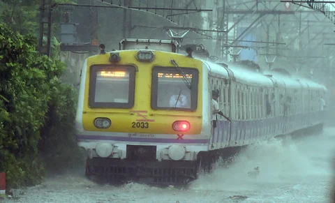 A train chugs at water-logged tracks during heavy rains in Mumbai on Saturday, June 09, 2018. (Source: PTI)