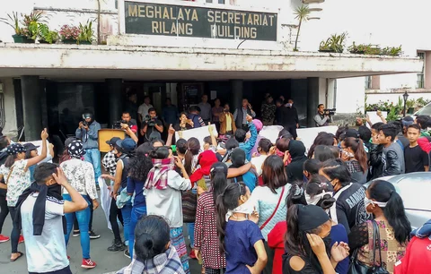 People from different parts of the city stage a protest Meghalaya Secretariat during curfew, in Shillong on Monday. (Source: PTI)