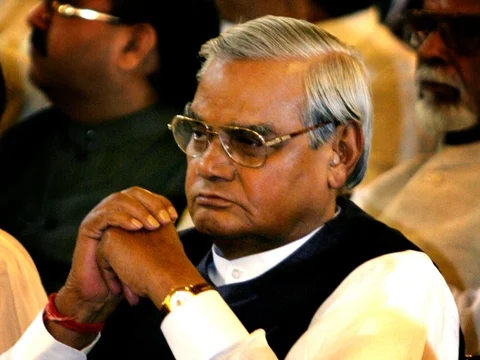 Then outgoing Indian Prime Minister Atal Bihari Vajpayee looks on as a new government under Manmohan Singh is sworn in during a ceremony in New Delhi on May 22, 2004. (Photographer: Amit Bhargava/Bloomberg News)