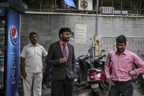 Devendra Jain, center, with his bodyguard, left, in Mumbai. (Photographer: Dhiraj Singh/Bloomberg)