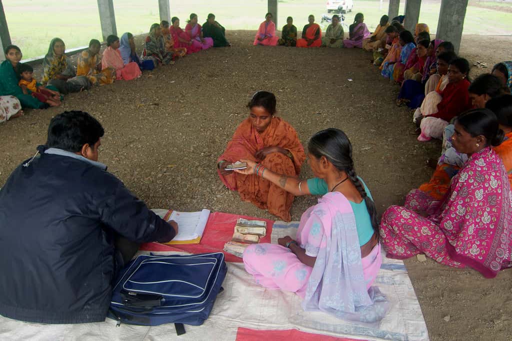 A woman receives a micro-loan during a meeting in Sadasivpet, India. (Photographer: Adeel Halim/Bloomberg)