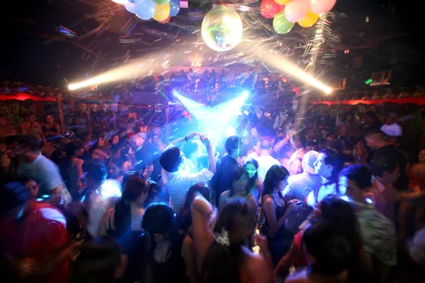 People dance on the floor at the disco bar La Conga, where some members of the FOL military base spend their spare time, in Manta, Ecuador (Photographer: Jorge Vinueza/Bloomberg News.) 