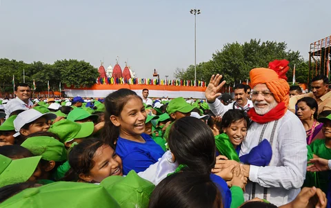 Prime Minister Narendra Modi interacts with children during Independence Day celebrations at the Red Fort, in New Delhi (Source: PTI)