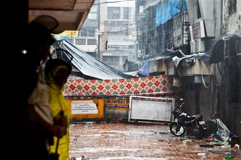Police officers stand guard near the site of a bomb explosion in the area of Zaveri Bazaar in Mumbai, India, on July 14, 2011. (Photographer: Kainaz Amaria/Bloomberg)