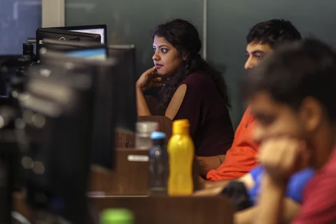 Employees work in front of computer monitors in a startup in Mumbai. (Photographer: Dhiraj Singh/Bloomberg)