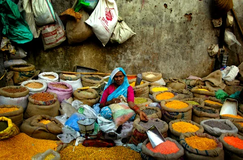 A woman sells pulses near a wholesale market in an old section of New Delhi. (Photographer: Amit Bhargava/Bloomberg News)