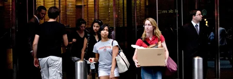 A woman carries a box as she leaves the headquarters of Lehman Brothers in New York, ahead of its bankruptcy filing, on Sept. 14, 2008. (Photographer: Tom Starkweather/Bloomberg News)
