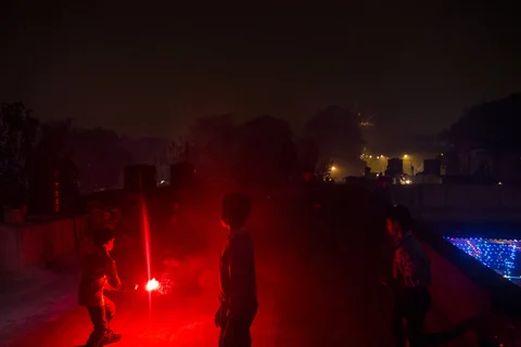 Children set off a firework during Diwali celebrations in the Khan Market area of New Delhi. (Photographer: Prashanth Vishwanathan/Bloomberg)