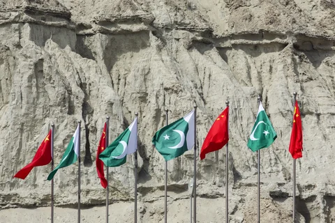 Chinese national flags fly next to Pakistani national flags at the Gwadar port in Balochistan, Pakistan. (Photographer: Asim Hafeez/Bloomberg)